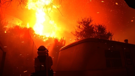 Firefighters struggle to contain wind-driven fire in Malibu threatening homes
